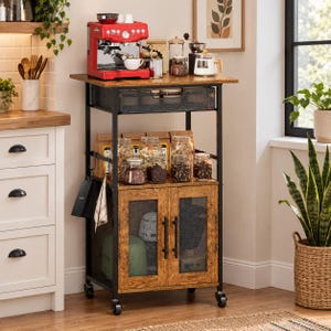 May include: A rolling kitchen cart with a brown wood-grain finish and a black metal frame. It features a top surface, a sliding mesh drawer, an open middle shelf holding glass jars, and a lower cabinet with two mesh doors and four caster wheels.