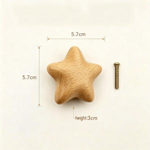 May include: A star-shaped wooden cabinet knob with a natural light brown wood grain finish. The knob measures 5.7 cm in width and 5.7 cm in length, with a height of 3 cm. A single metal mounting screw is positioned to the right of the wooden knob.