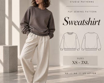 May include: A PDF sewing pattern for a sweatshirt by Siama Studio Patterns. The image displays a brown long-sleeve sweatshirt, white wide-leg trousers, and white sneakers. Includes line drawings of the front and back, sizes XS-3XL, and A0, A4, US Letter formats.