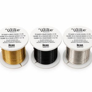 May include: Three spools of 20 gauge tarnish-resistant wire by The Bead Smith. Each spool contains 15 yards of wire in brass, black, and silver colors. The white labels feature the brand name WiRe elements and technical specifications.