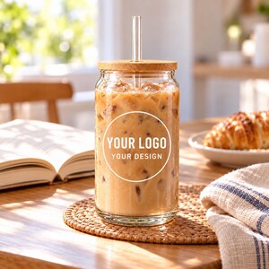 Iced coffee glass cup with your logo placeholder on a breakfast table.