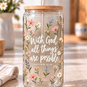 Digital mockup of a clear glass cup showing With God All Things Are Possible and Matthew 19:26 lettering with wildflowers. Bamboo lid shown.