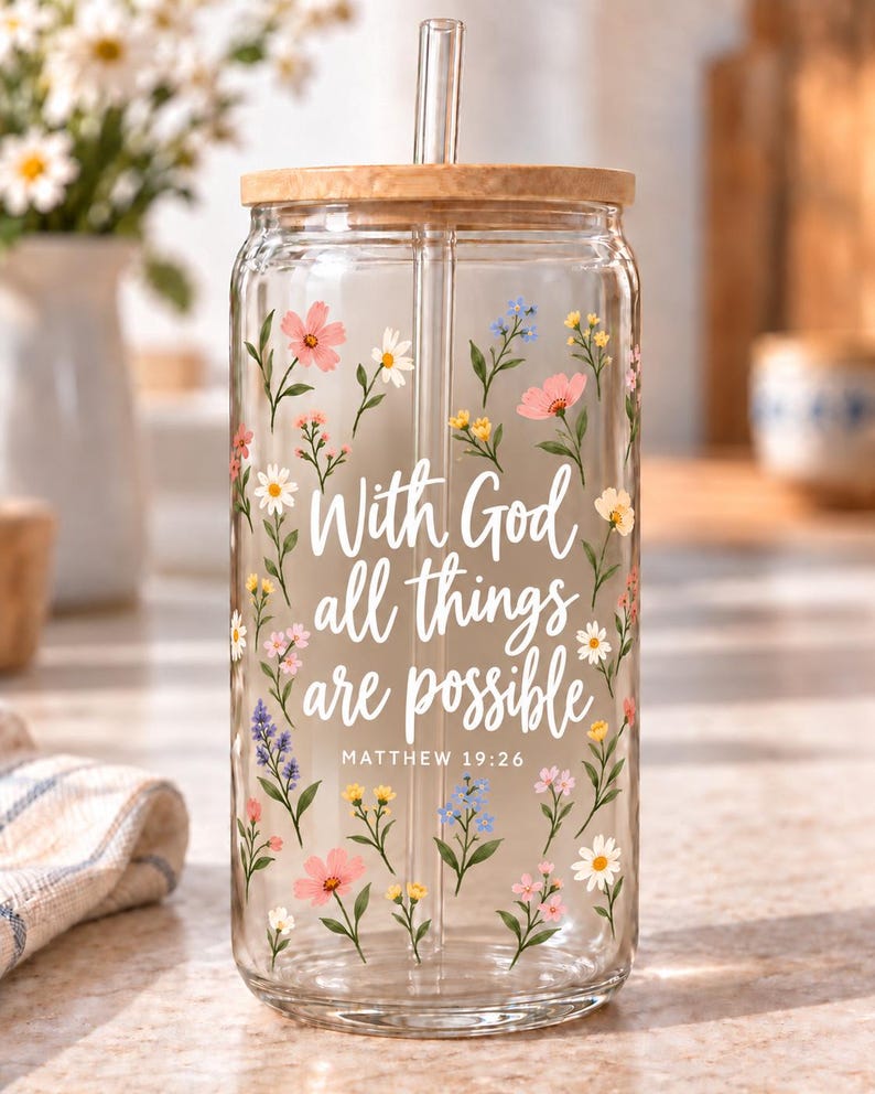 Digital mockup of a clear glass cup showing With God All Things Are Possible and Matthew 19:26 lettering with wildflowers. Bamboo lid shown.