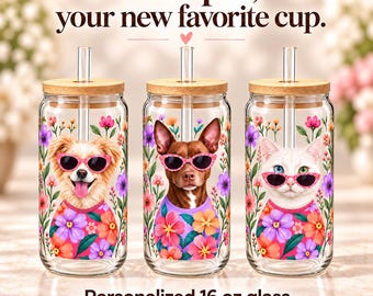 May include: Three clear glass tumblers with bamboo lids and glass straws. Each features a pet wearing pink sunglasses and a floral shirt, surrounded by colorful flowers. Text reads: Your pet, your new favorite cup. Personalized 16 oz glass.