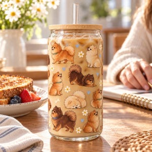 Pomeranian pattern glass cup with bamboo lid and glass straw in an everyday scene.