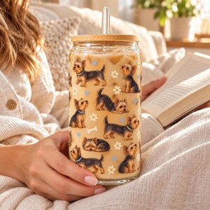 Yorkshire Terrier pattern glass cup with bamboo lid and glass straw in an everyday scene.