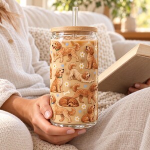 Goldendoodle pattern glass cup with bamboo lid and glass straw in an everyday scene.