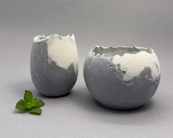 Two gray & white concrete vessel sculptures. Sustainable. Live edge bowls. Natural shiny outside surface. Wabi-sabi style.