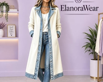 May include: A long, cream-colored ribbed knit duster coat featuring a blue denim collar, front placket, and hem trim. The coat is worn over a white top and blue jeans. The text ElanoraWear is visible in the upper right corner of the image.