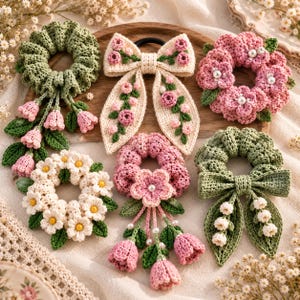 May include: A collection of six crocheted hair accessories including floral scrunchies and bows. The items feature pink, white, and green yarn, with details like small flowers, leaves, dangling tulip-shaped charms, and white pearl-like beads.