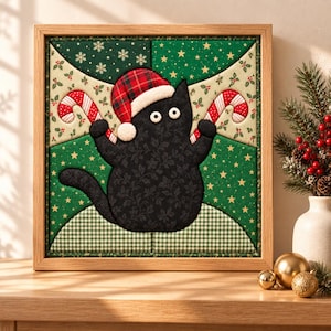 May include: A square framed fabric wall art piece featuring a black cat with white button eyes wearing a red and green plaid Santa hat. The cat holds two red and white striped candy canes against a background of green fabric with stars.