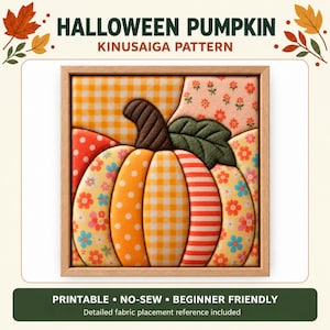 May include: A square wooden frame containing a Kinusaiga pattern of a pumpkin. The pumpkin is composed of fabric segments featuring orange gingham, red polka dots, floral prints, and stripes. A dark brown stem and a dark green leaf are included.
