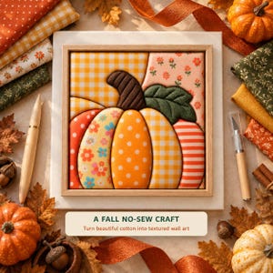 May include: A square framed wall art piece featuring a fabric-covered pumpkin with segments in yellow gingham, orange polka dots, floral patterns, and stripes. A dark brown stem and green leaf sit atop the pumpkin. Text reads A FALL NO-SEW CRAFT.