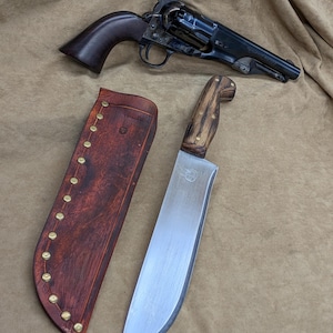 May include: A black revolver with a wooden grip is above a large knife with a wooden handle and a leather sheath. The knife blade is silver, and the sheath is brown with brass rivets.
