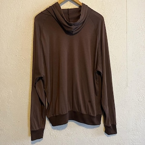 May include: A brown hoodie with long sleeves and a drawstring hood. The cuffs and hem are a darker shade of brown. The hoodie is made of a soft, lightweight material.