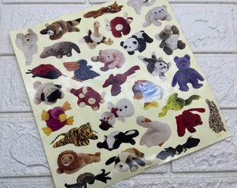 May include: A rectangular sticker sheet featuring a collection of various animal-shaped plush toy illustrations. The stickers include a lion, tiger, panda, pig, dog, cat, bird, and other creatures in diverse colors, arranged on a light cream background.