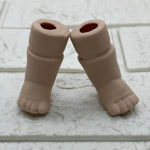 Un par de pies de muñeca de porcelana vintage