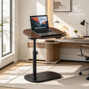 May include: A height-adjustable mobile laptop desk with a dark brown, kidney-shaped wooden top and a black metal base. The desk features a central vertical support pole with a manual adjustment knob and a laptop computer placed on the surface.