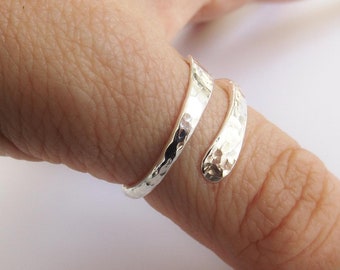 May include: A silver hammered wrap ring for a finger.