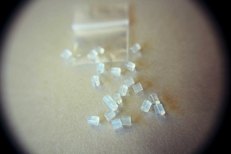 May include: A close-up of a pile of small, clear, plastic earbud tips.