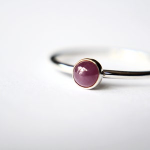 Peut inclure: Une bague en argent avec une pierre pr&eacute;cieuse rose ronde sertie.