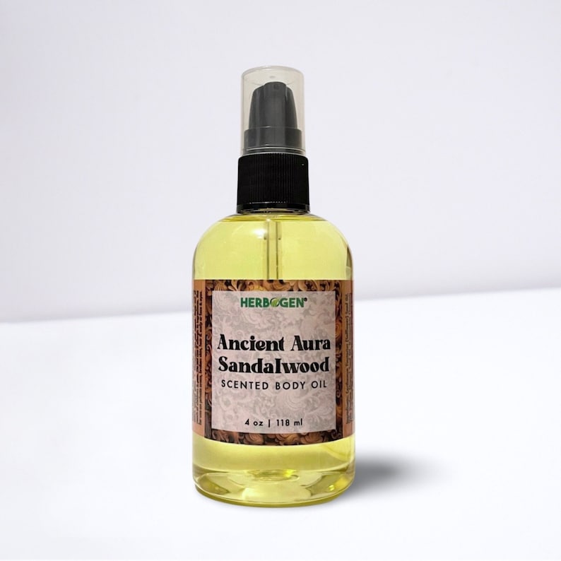 May include: A clear glass bottle with a black pump top and a yellow liquid inside. The bottle is labeled "Herbogen Ancient Aura Sandalwood Scented Body Oil 4 oz | 118 ml".