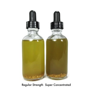 May include: Two glass bottles with dropper tops filled with a yellow liquid. The bottle on the left is labeled "Regular Strength" and the bottle on the right is labeled "Super Concentrated".