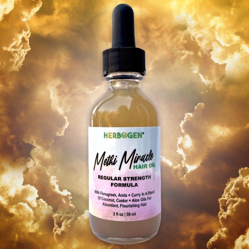 May include: A brown glass bottle with a dropper top, labeled "HERBOGEN Methi Miracle HAIR OIL REGULAR STRENGTH FORMULA With Fenugreek, Amla + Curry In A Blend Of Coconut, Castor + Aloe Oils For Abundant, Flourishing Hair 2 fl oz | 59 ml"