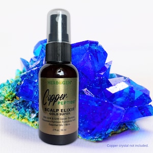 May include: A dark amber spray bottle of Herbogen Copper Peptide Scalp Elixir Gold Super. The label lists AHK and GHK copper peptides, rosemary hydrosol, hyaluronic acid, and essential oils. The bottle contains 2 fluid ounces or 59 milliliters.