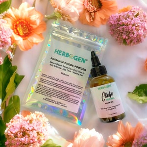 May include: A silver pouch with a white label that reads "HERB GEN® PREMIUM CHEBE POWDER Natural Growth Secret From Chad Used To Help Cultivate Long, Thick + Healthy Hair 50 Grams" and a brown glass bottle with a white label that reads "HERBOGEN Chebe HERBAL HAIR OIL With Chebe, Clove + Peppermint Oil in Pure Olive Oil 2 fl oz / 59 ml".