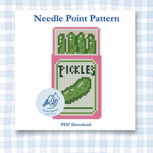 May include: A needlepoint pattern PDF download featuring a pixelated graphic of a pink jar labeled Pickles with green pickles inside. The design includes the text Needle Point Pattern at the top and PDF Download at the bottom with a circular logo.