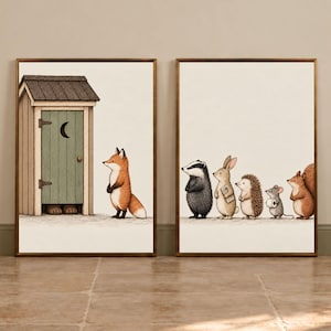 May include: Two framed wall art prints featuring woodland animals. The first shows a fox standing by a wooden outhouse with a crescent moon cutout. The second shows a badger, rabbit, hedgehog, mouse with toilet paper, and squirrel in a line.