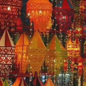 May include: A collection of hanging fabric lanterns in various shapes and sizes, featuring vibrant colors like red, orange, yellow, and green. The lanterns are decorated with intricate geometric patterns, embroidery, and small mirrors, illuminated by strings of tiny lights.