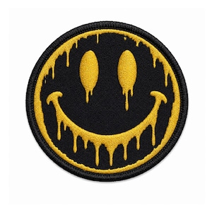 Geborduurd smileygezichtje, zwart-gouden druppelbadge