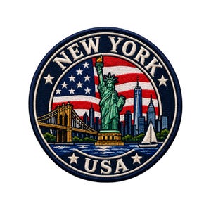May include: A circular embroidered patch featuring the Statue of Liberty, the Brooklyn Bridge, and the New York City skyline against an American flag background. The text NEW YORK is arched at the top and USA is at the bottom with white stars.