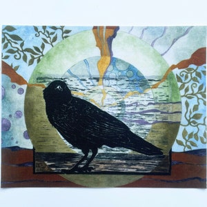 May include: A rectangular art print featuring a black crow silhouette. The crow is perched on a wooden beam, set against a backdrop of a green circle, blue sky, and brown and green foliage. The artwork has a textured, printmaking style.