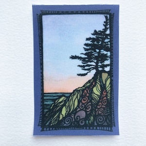 May include: A colorful embroidered patch with a silhouette of a pine tree on a cliff overlooking a wavy ocean. The sky is a gradient of pink, orange, and blue. The patch is framed with a black border.