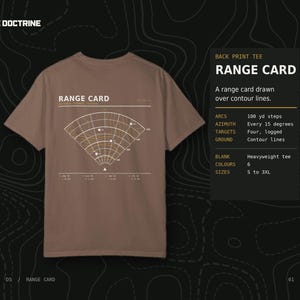 May include: A brown short-sleeve t-shirt featuring a white and yellow graphic on the back. The graphic displays a range card with contour lines, arcs at 100 yd steps, and azimuth markings. The text RANGE CARD is printed above the diagram.