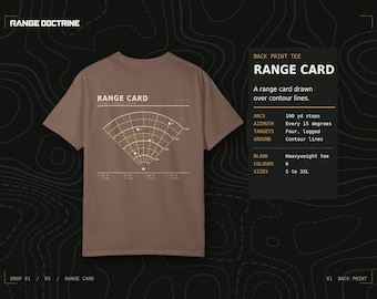 May include: A brown short-sleeve t-shirt featuring a white and yellow graphic on the back. The graphic displays a range card with contour lines, arcs at 100 yd steps, and azimuth markings. The text RANGE CARD is printed above the diagram.
