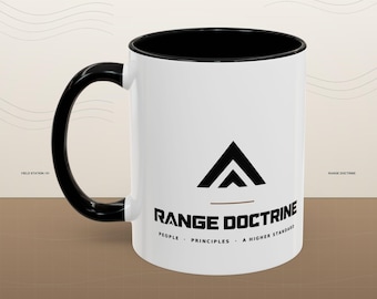 May include: A white ceramic mug with a black interior and a black handle. The front features a black triangular logo above the text RANGE DOCTRINE, with the words PEOPLE, PRINCIPLES, A HIGHER STANDARD printed in smaller black lettering below.