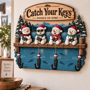 May include: A wooden wall-mounted key holder featuring four snowmen wearing Santa hats and scarves, each holding a fishing rod. The sign reads Catch Your Keys and Hooked on Home, with four black metal hooks hanging below as fishing lures.