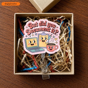 May include: A badge reel featuring a pink, scalloped-edge acrylic topper with the text "But did you document it?" and cartoon illustrations of a smiling laptop, a clipboard with a pen, and a steaming coffee mug with a happy face.