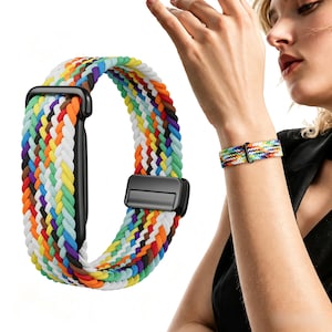 May include: A braided watch band featuring a vibrant, multi-colored pattern of red, orange, yellow, green, blue, purple, and white threads. The band includes a black rectangular connector and a black sliding buckle for adjustable sizing.