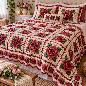 May include: A handmade crochet bedspread and matching pillows featuring a repeating square pattern with three-dimensional dark red roses and dark green leaves on a cream-colored background, finished with a scalloped edge of small red roses.