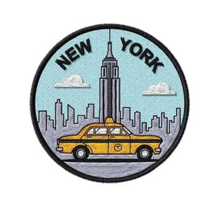 May include: A circular embroidered patch featuring a yellow taxi cab in the foreground with a light blue sky, white clouds, and a grey skyline of New York City buildings, including the Empire State Building, with the text NEW YORK arched above.