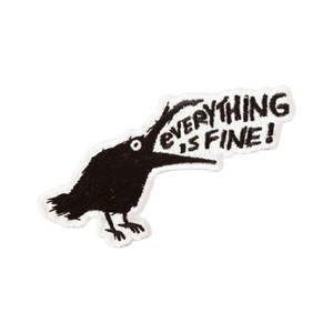 May include: An embroidered patch featuring a black bird with a white eye, depicted with its beak open. A speech bubble extends from the bird's beak, containing the black embroidered text "everything is fine!" on a white background.