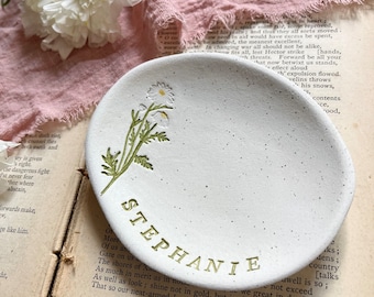 May include: White ceramic trinket dish with a green floral design and the name "STEPHANIE" written in gold lettering.