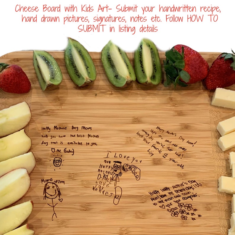 May include: A wooden cutting board with a variety of fruits and cheese arranged on it. The board is decorated with handwritten messages and drawings from children. The messages include "Happy Mother's Day Mom" and "I Love You".