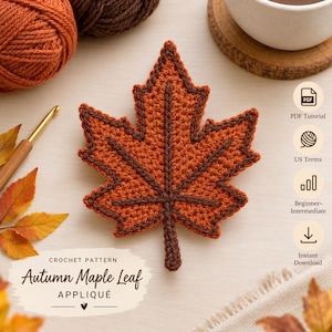 May include: A crochet pattern for an autumn maple leaf appliqué. The design features a central orange leaf with dark brown stitched veins and a dark brown border. Text includes "CROCHET PATTERN Autumn Maple Leaf APPLIQUÉ", "PDF Tutorial", "US Terms", "Beginner-Intermediate", and "Instant Download".