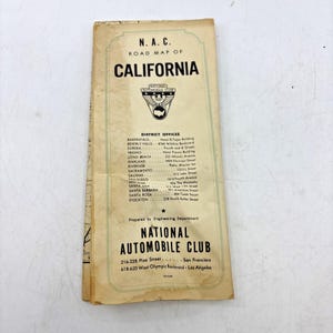 May include: A vintage N.A.C. Road Map of California, featuring a cream-colored paper cover with black text and the National Automobile Club logo. The cover lists district offices across California and addresses in San Francisco and Los Angeles.